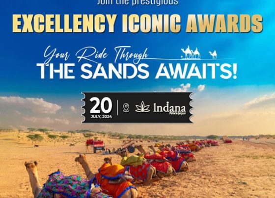A group of camels rest on a sandy beach with text about the Excellency Iconic Awards.