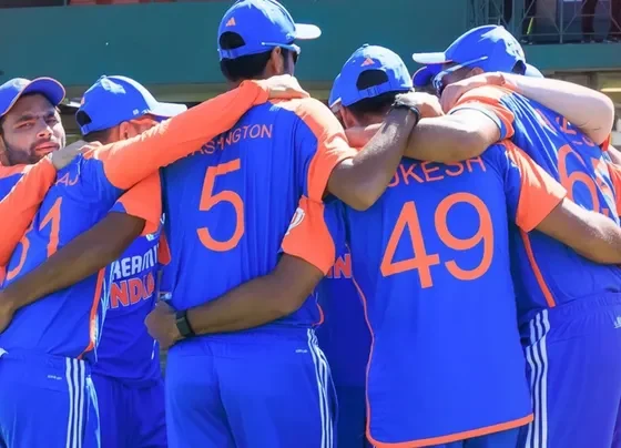 A cricket team huddle before a match between India and Zimbabwe.